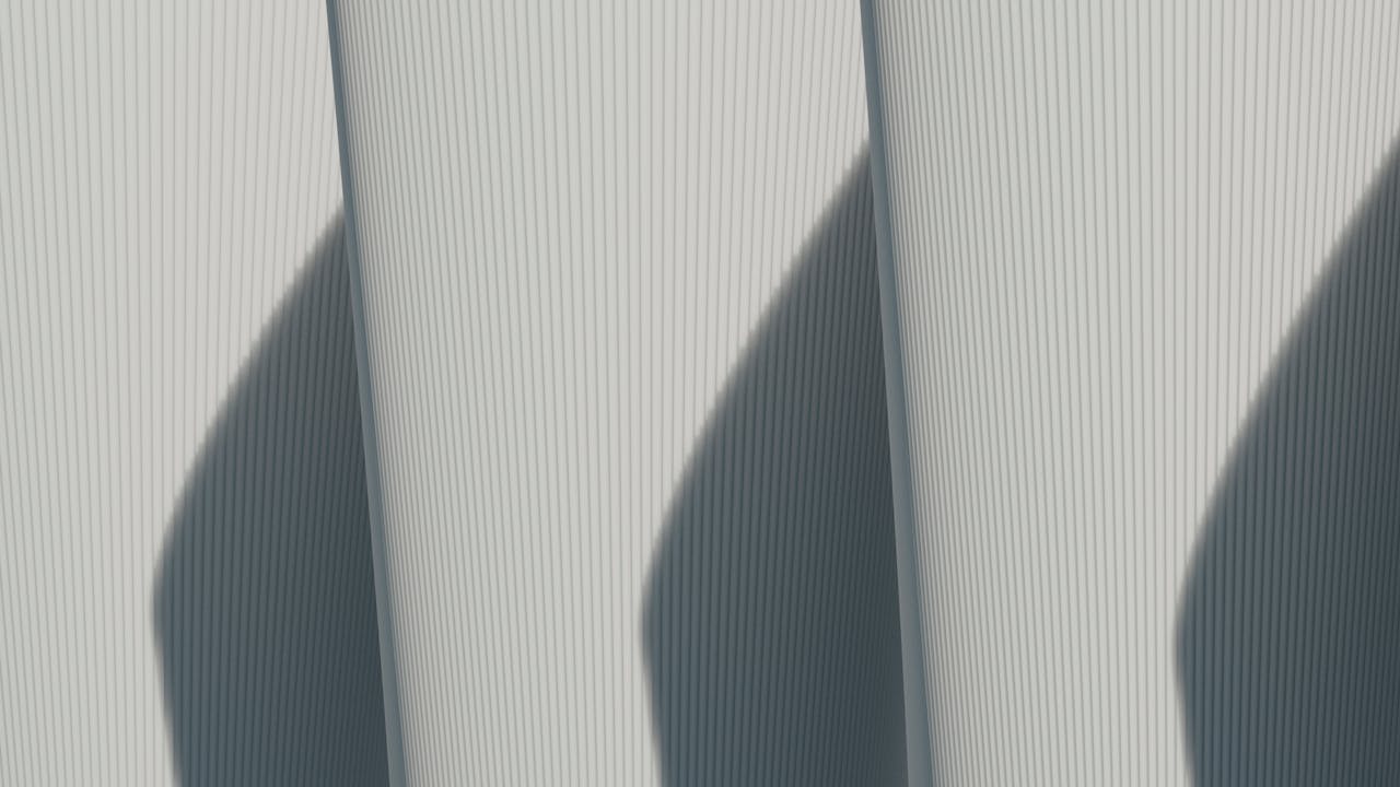 our-story-02 Abstract architectural image showcasing minimalist lines and strong shadows.